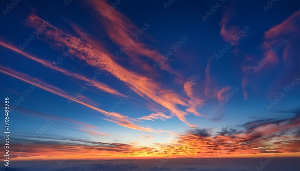 Fototapeta premium Fire On The Sky From High Above Far Sunset And Orange And Red Colored Streakes Of Cirrus Clouds On Deep Blue Evening Sky Ideal For Sky Replacement Projects No Obstacles In The Front