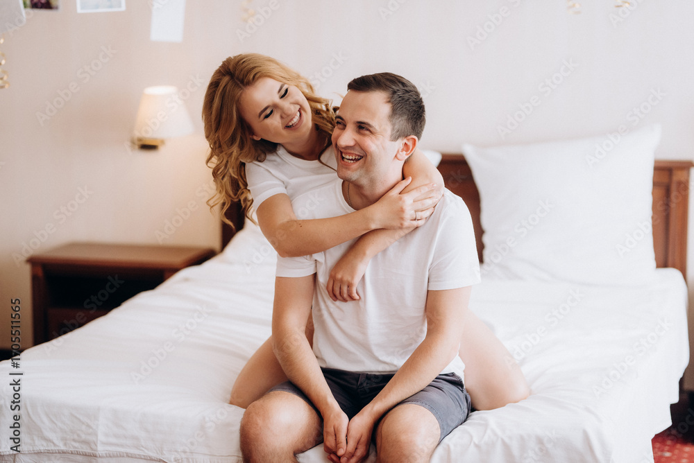 young couple bride and groom in the morning in a hotel room young couple bride and groom in the morning in a hotel room