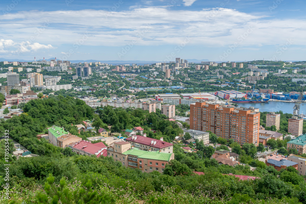 Naklejka premium Panorama of Lugovaya street in Vladivostok, Primorsky krai, Russia, with Sollers factory and docks at Golden Horn bay, during sunny weather, autumn.