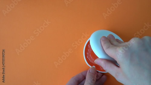  Opening White and Orange Dental Aligner Case that are Orthodontic Mouthpiece storage in orange background. Slow motion. copy space.