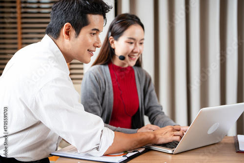 Leader, trainer, and manager in a call center are coaching a telemarketing employee to provide high-quality customer service.