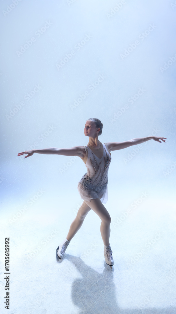 Obraz premium Graceful figure skater extending arms in balanced pose under soft light. Concept of wellness harmony, art expression, lifestyle performance, and cultural beauty.