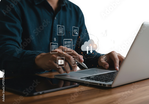 Person using laptop with digital cloud and data icons