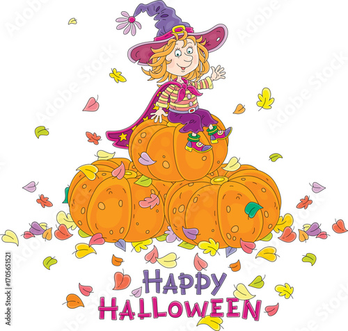 Happy little Halloween witch with a big hat and a cloak with stars sitting on a pile of large orange pumpkins among colorful autumn leaves and waving in greeting, vector cartoon postcard