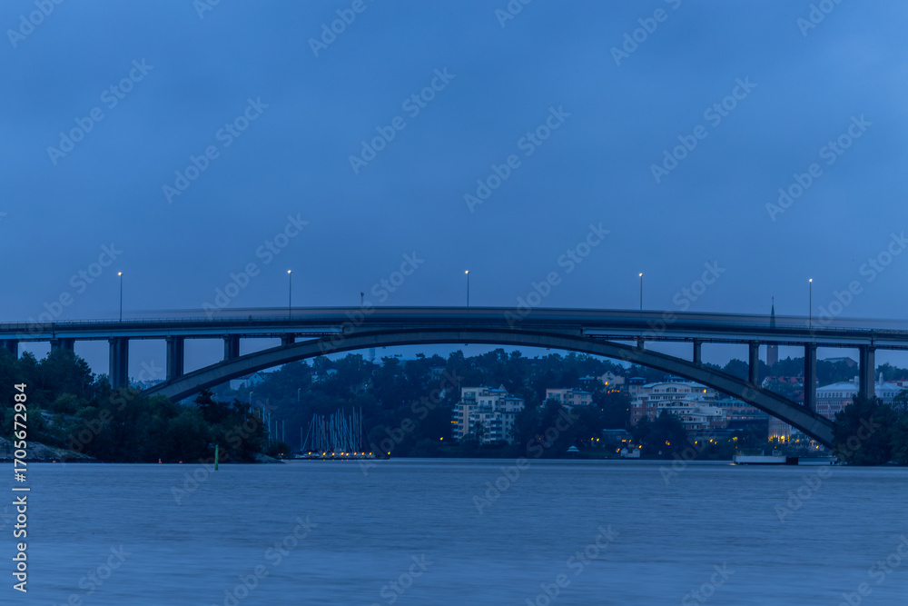 Naklejka premium Stockholm, Sweden A tunnelbana or subway train passes over the Tranebergsbron in the early morning.