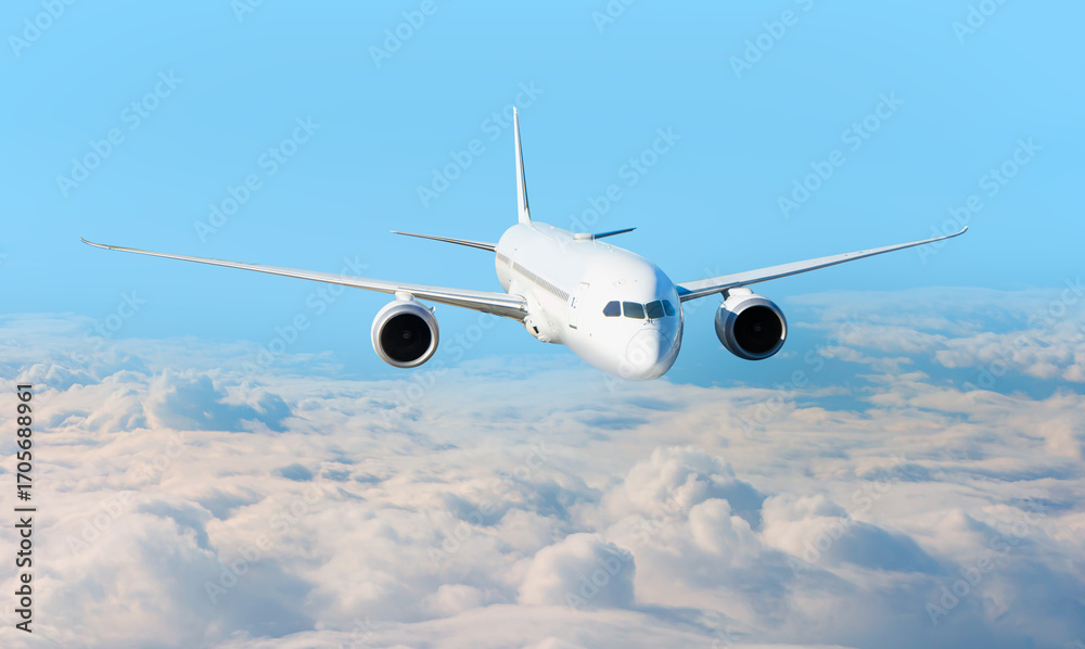 Obraz premium White passenger airplane flying in the sky amazing clouds in the background - Travel by air transport