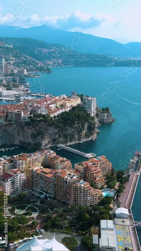 Vertical 4K drone video Monaco's legendary Rock cliff with Prince's Palace overlooking luxury marina and Mediterranean. Epic aerial footage of billionaire's playground for mobile video platforms.