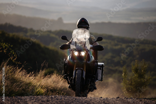 Man on his motorbike riding at sunset