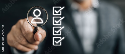 A person in a suit holds a magnifying glass over a silhouette of a person, next to glowing checklist marks