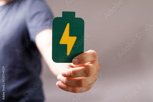 Hand holding a green batter...
