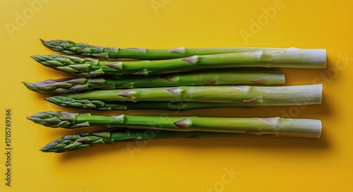 Fresh Asparagus Spears on a Vibrant Yellow Background Showcasing Healthy Vege...