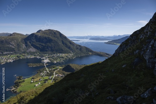 Expansive coastal landscape with mountains, sea and the village of Midsund, Otroya or Otrøya Island, Møre og Romsdal, Norway