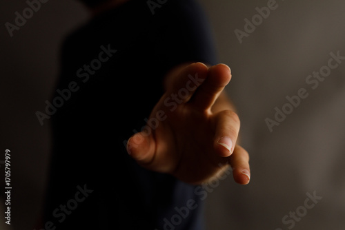 Close-up of a hand reaching...