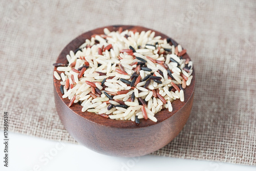 Close up of brown rice on a wooden bowl and copy space. Healthy food.