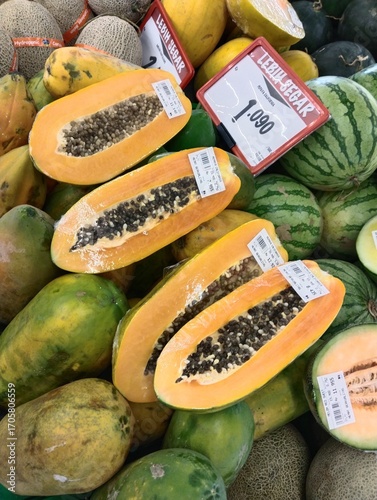 piles of papayas in supermarket display baskets, a bunch of papayas for sale in a store, fresh papayas in store baskets