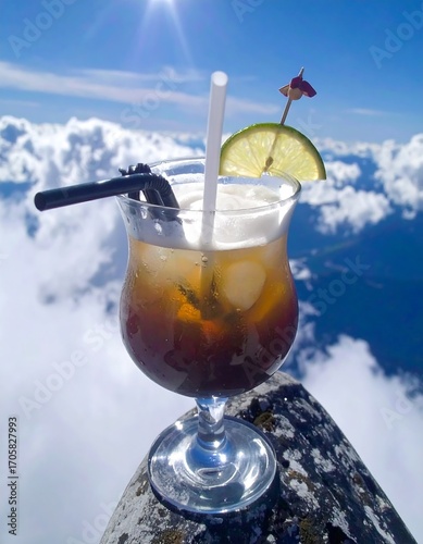 Cocktail atop a mountain peak, clouds below, sunny day