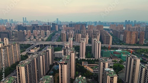 Overhead perspective of residential buildings in Hangzhou, China, featuring many apartments and some traffic flow