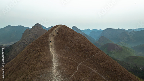 Slika na platnu Dawn on the high mountain peaks of Ha Lang area, with pack horses and people going to work