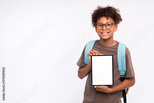 Vászonkép Smiling African-American school preteen boy elementary primary pupil holding usi