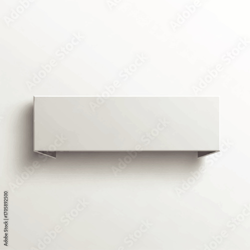 A simple, rectangular, white shelf is mounted on a white wall, casting a soft shadow
