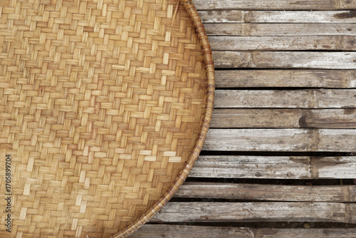 A close-up of a traditional Javanese woven bamboo rice winnower called 