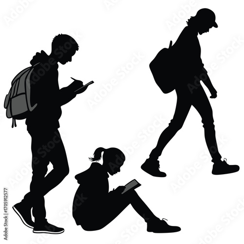 Students using digital tablets and writing in notebooks; silhouettes of studying young people