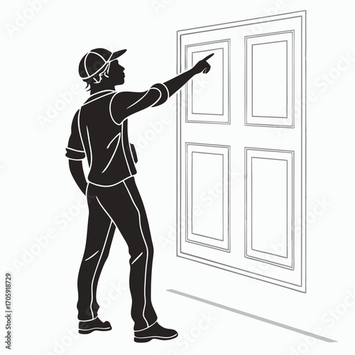 Man in silhouette wearing a cap pointing to the wall with paneling