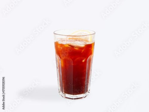 Chilled iced americano coffee with a fresh lemon slice, served in a clear glass with ice cubes and condensation, isolated on a light background