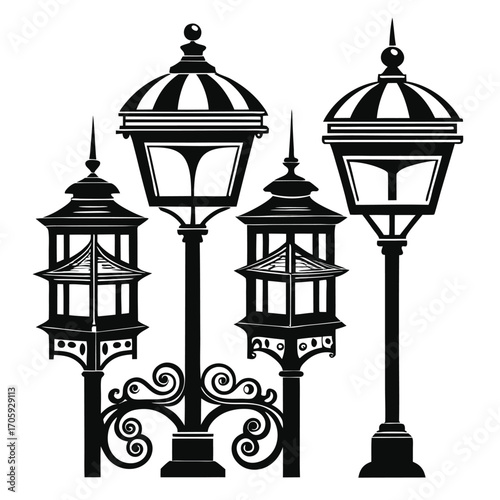Four ornate streetlights stand together, creating a striking black and white silhouette arrangement
