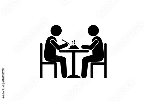 2 figures sit at a table with a steaming plate of food one holds utensils