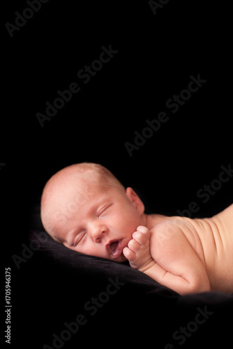 Newborn Baby Sleeping Peacefully - Portrait Isolated on Black