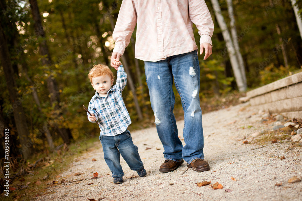 Fototapeta premium Father and Toddler Son on Nature Walk on Path Through Woods