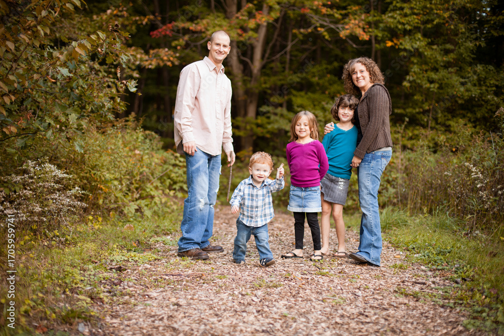 Fototapeta premium Happy Family on Nature Walk Together on Path Through Forest