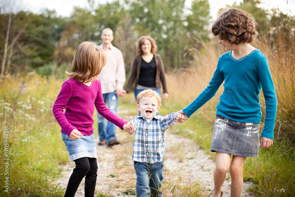 Fototapeta premium Happy Children Walking with Father and Mother in Nature
