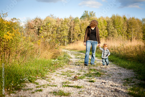 Mom and Toddler Son Walking Together Outside