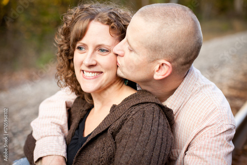 Husband Giving Happy Wife a Kiss Outside - Portrait