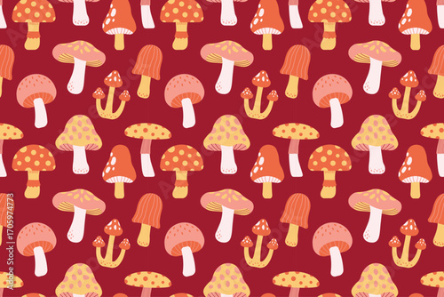 Seamless autumn mushroom pattern in orange, yellow, pink, and white tones on red background. Great for seasonal crafts and design.
