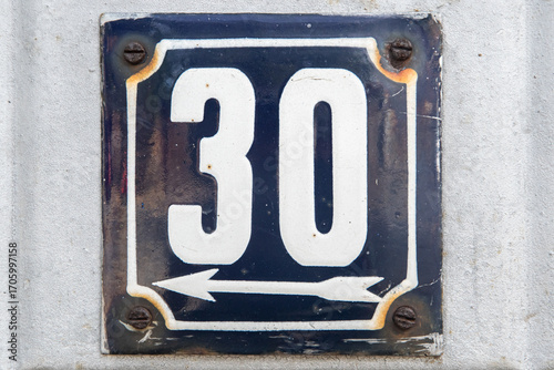 Weathered grunge square metal enameled plate of number of street address with number 30