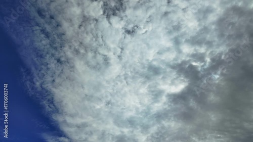 A time lapse of a cloudy sky, movement away from the camera.