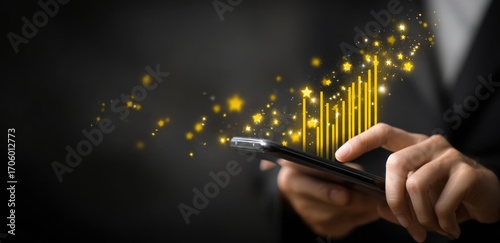 Close-up of hands using a smartphone, with shimmering yellow digital bars rising and glittering stars around it, on a dark background