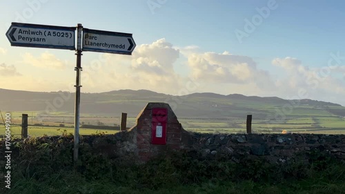 Time-Lapse of clouds moving over a rural landscape at sunrise near Llanerchymedd on the Isle of Anglesey in Gwynedd off the north Wales coast.
