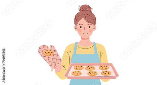 Smiling woman with a bun hairstyle holding a tray of freshly baked chocolate chip cookies.