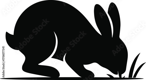 Minimal vector silhouette, rabbit nibbling grass head down, side view, solid black