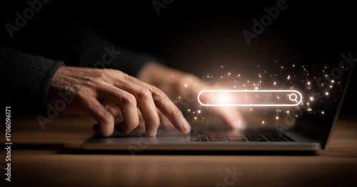 Laptop, wood desk, and a person's fingers typing under a glowing search bar graphic. Dark background and lighting enhance the focus