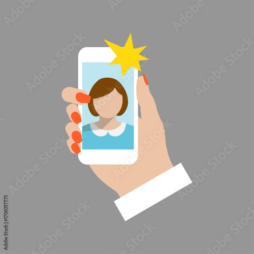 Woman taking a self-portrait photo using a mobile phone camera flash