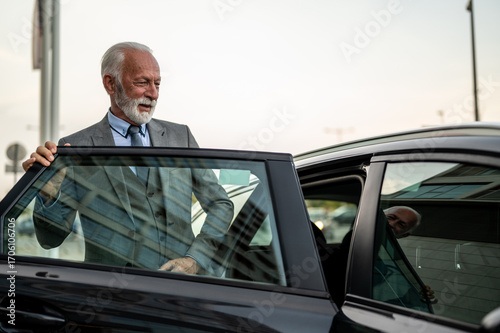 фотографія Senior businessman exiting car, ready for business meeting