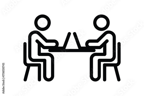 Two people working together on laptops at a table