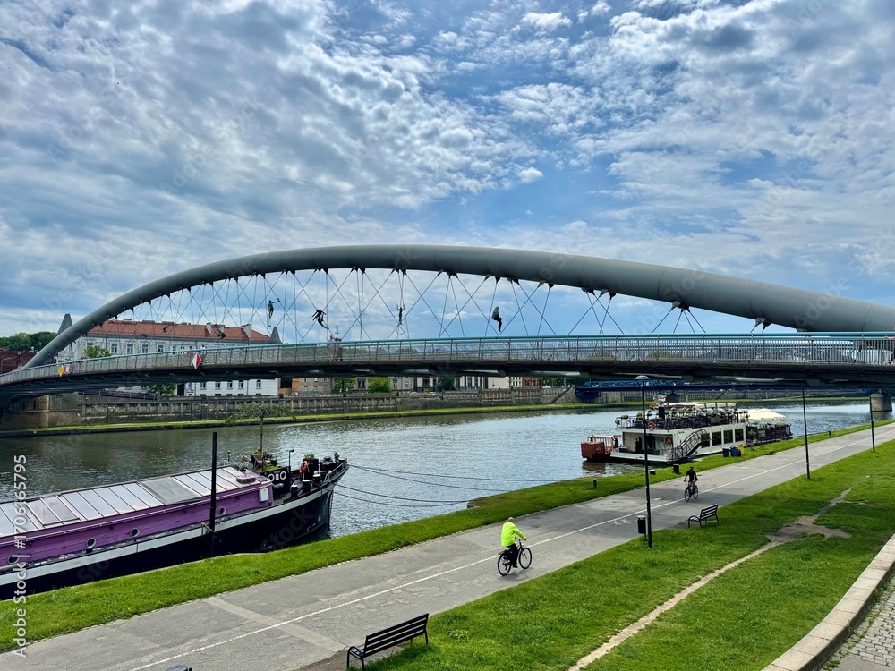 Fototapeta premium Bridge across the river in Krakow Poland with the blue sky on the background