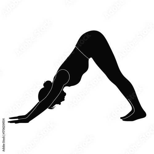 Silhouette of a woman in downward facing dog yoga pose on silhouette
