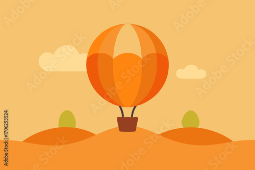 Orange hot air balloon over rolling hills and clouds